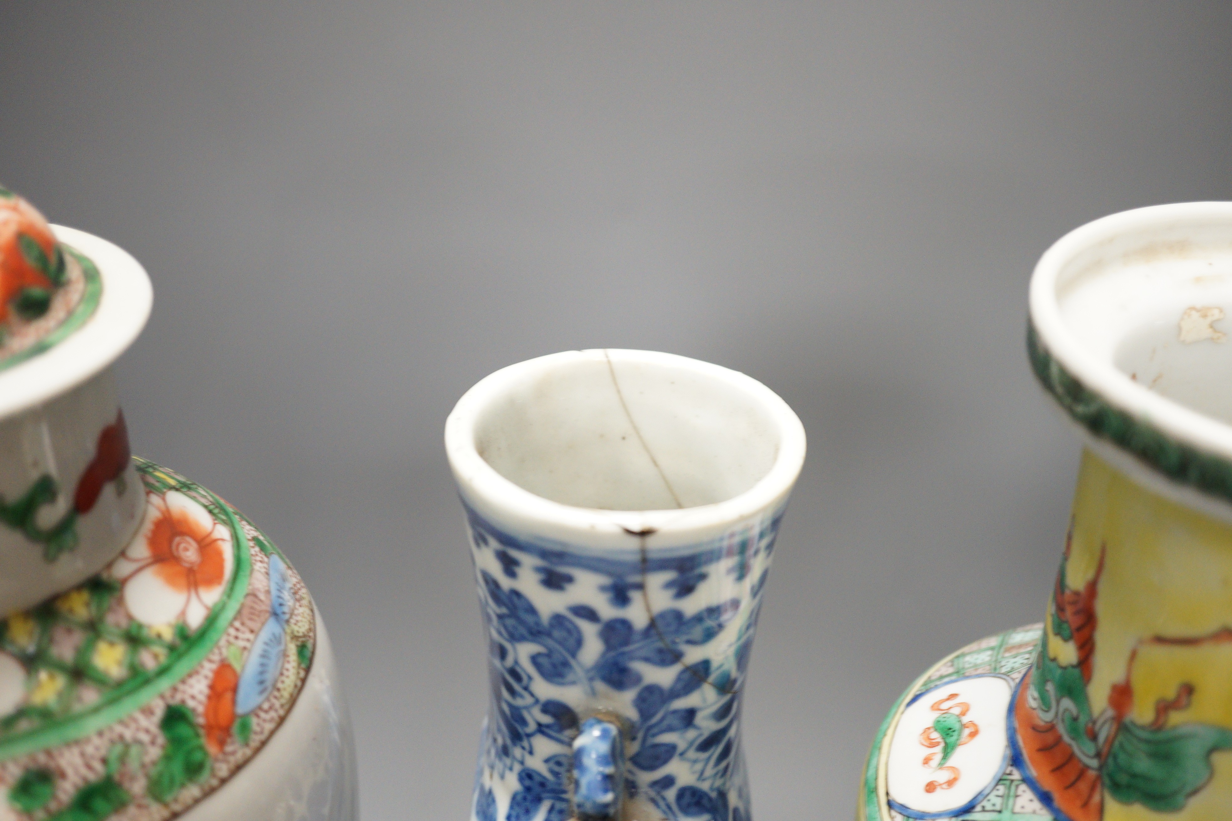 A Chinese famille verte vase and cover, a yellow ground ‘soldiers’ vase, a blue and white moonflask and a similar’dragon’ sleeve vase, all late 19th/early 20th century, Tallest 33cm